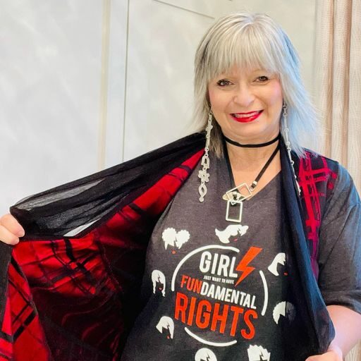 Tina is showing her t-shirt that says Girls Just want to Have Fundamental Rights.